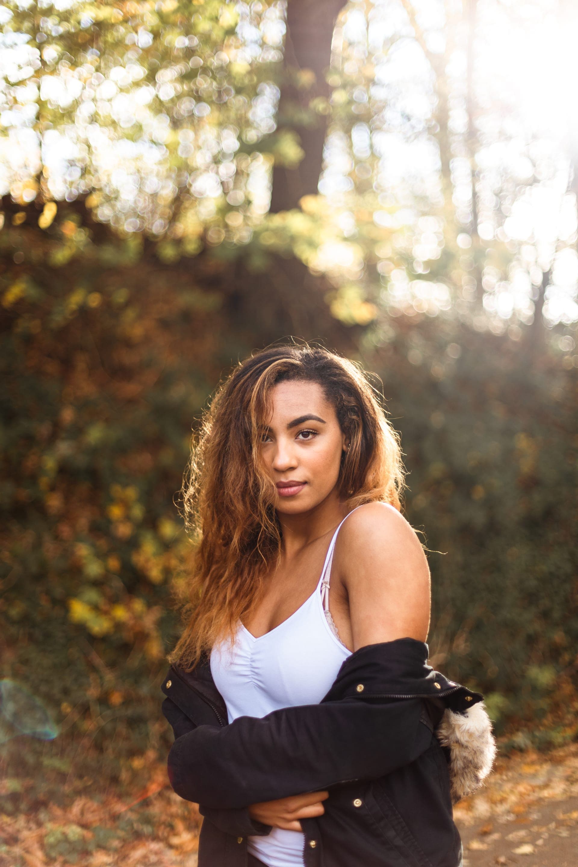 Portrait femme en contre-jour bras croisés veste sombre automne — séance portrait intime